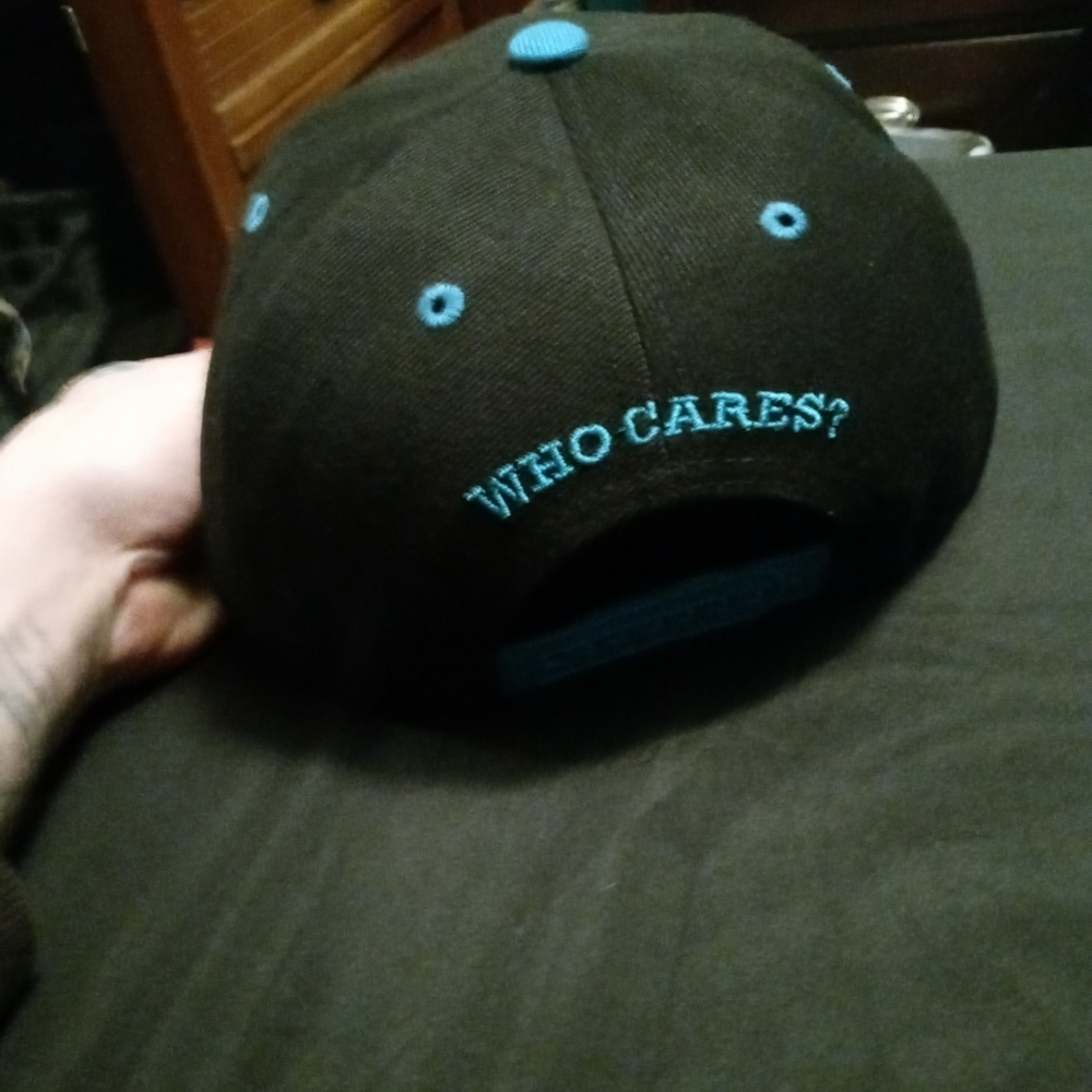 Snapback hat with who cares embroidered in it
